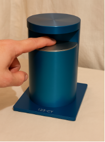 123-CY diagnostic device prototype, a fingertip-scanning cylinder unit, shown with a finger resting on the scan surface